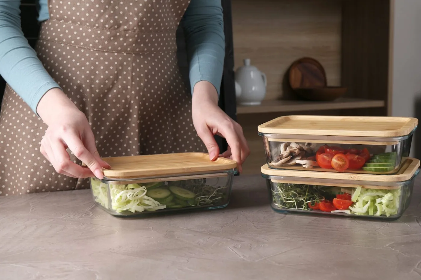 Woman preparing meals in glass containers